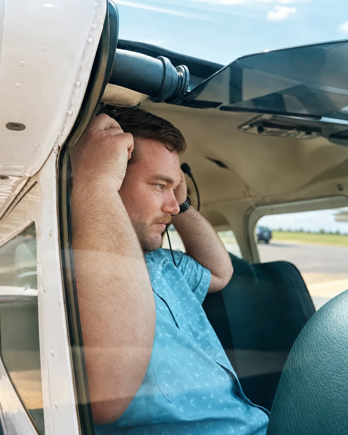 Jonathan Wieting putting on a headset in a general aviation aircraft